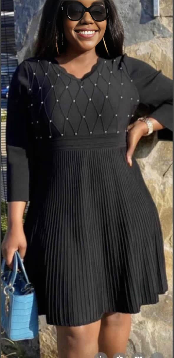 Dark knit midi dress with pleated skirt and bead-studded diamond yoke