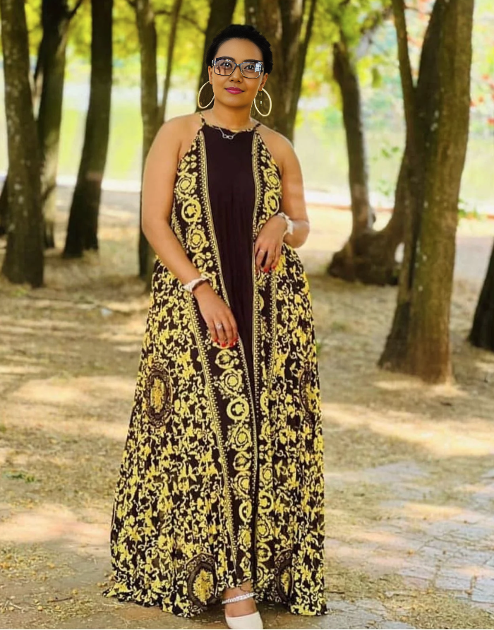 Sleeveless maxi dress with black and yellow patterned skirt and contrasting dark bodice