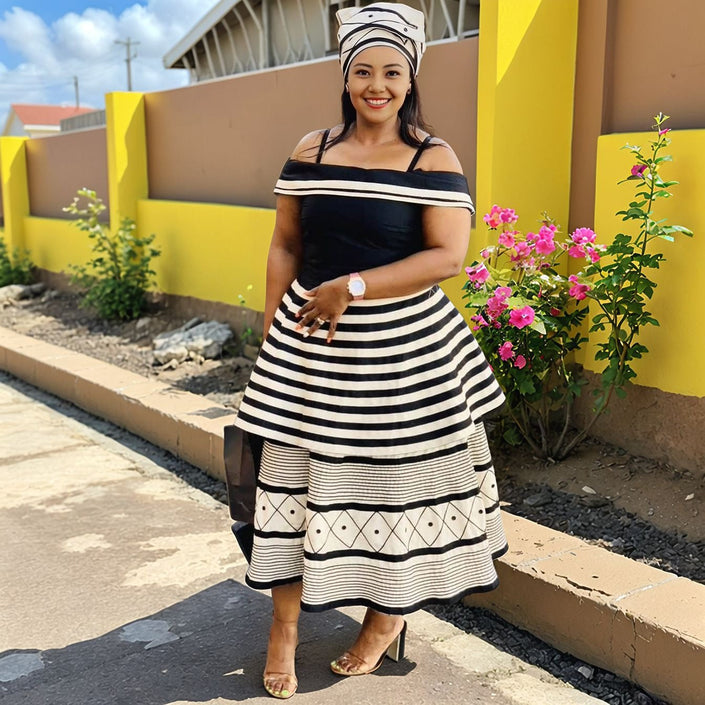 Off-shoulder tiered midi dress with black-and-white stripes and geometric hem print