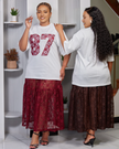 Twin set on model: white sequin number T‑shirt and maroon lace midi skirt