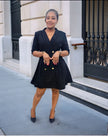 Black double-breasted blazer dress with gold buttons and V-neck, flared mini skirt.