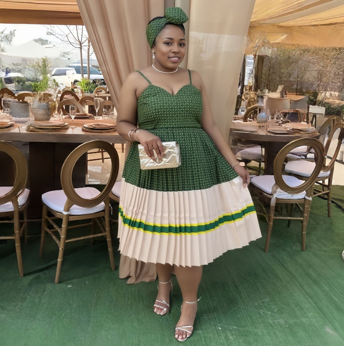 Pleated midi dress with thin straps, green patterned bodice and striped hem