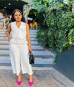 White sleeveless vest and wide-leg trousers with buttoned V-neck detail