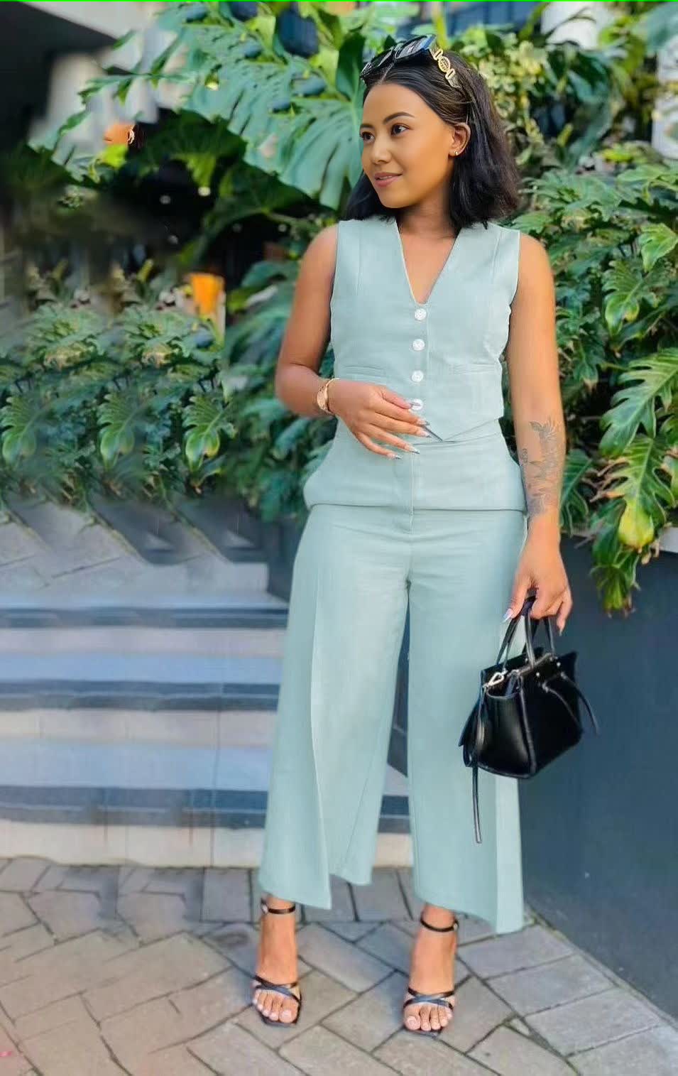 Sky-blue sleeveless vest and wide-leg trousers with buttoned V-neck detail