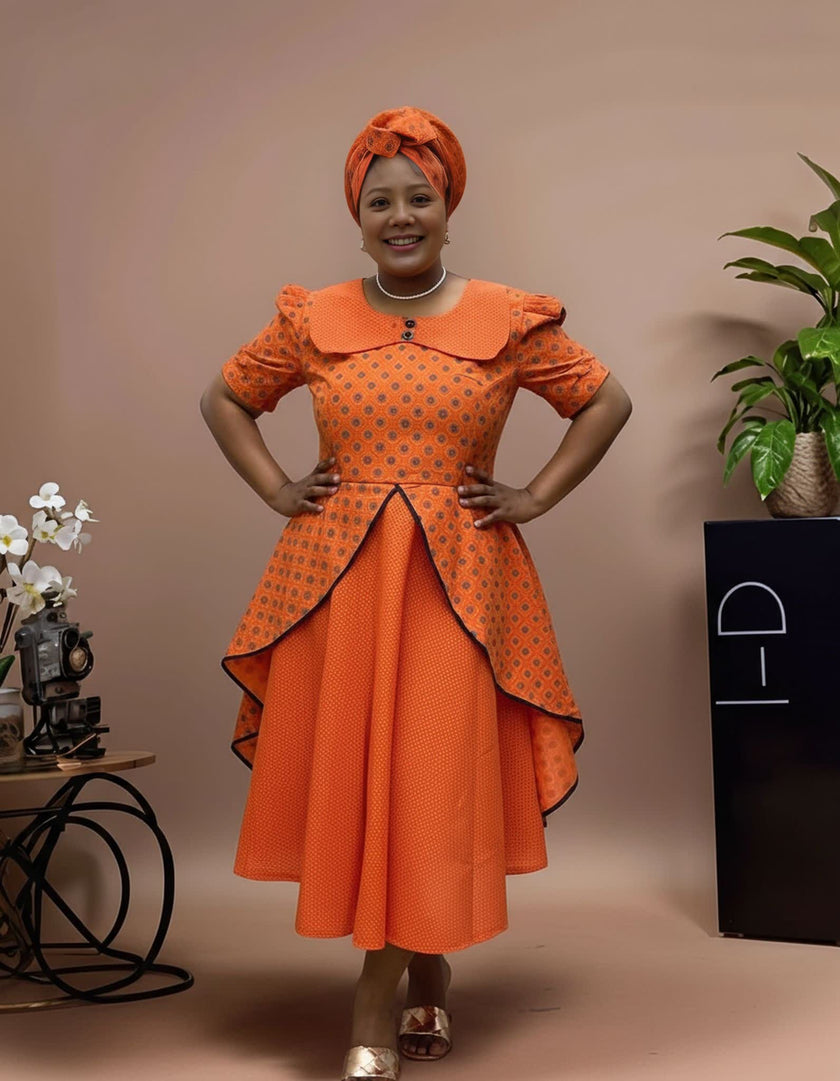 Orange patterned midi dress with puff sleeves and layered skirt flounces