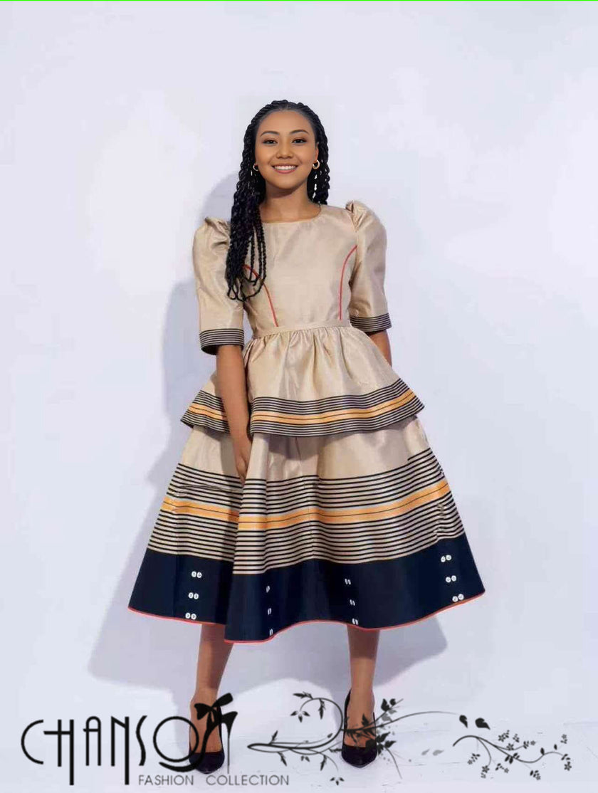 Beige midi dress with puff sleeves, striped tiered skirt in navy and orange accents