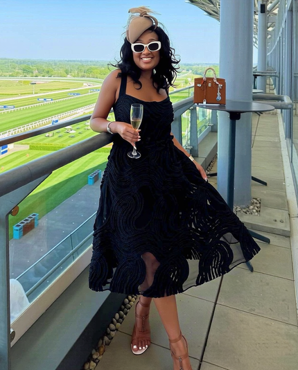 Black sleeveless swirl-texture midi dress, fitted bodice and flared skirt