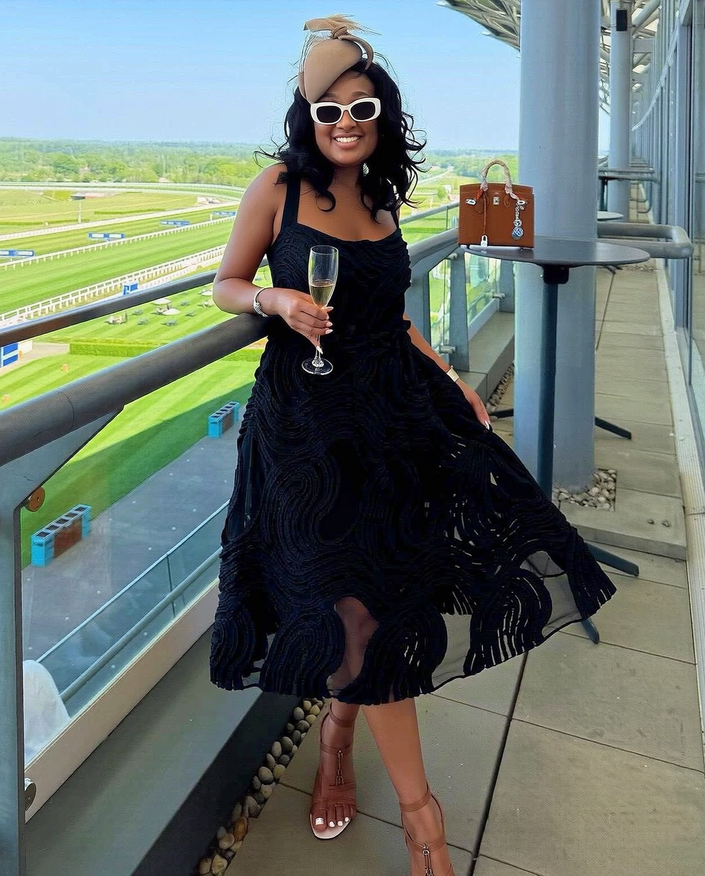 Black sleeveless swirl-texture midi dress, fitted bodice and flared skirt
