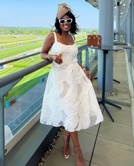 White sleeveless swirl-texture midi dress with fitted bodice and flared skirt