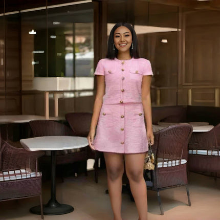 Pink button-front short-sleeve jacket and matching mini skirt suit, gold buttons