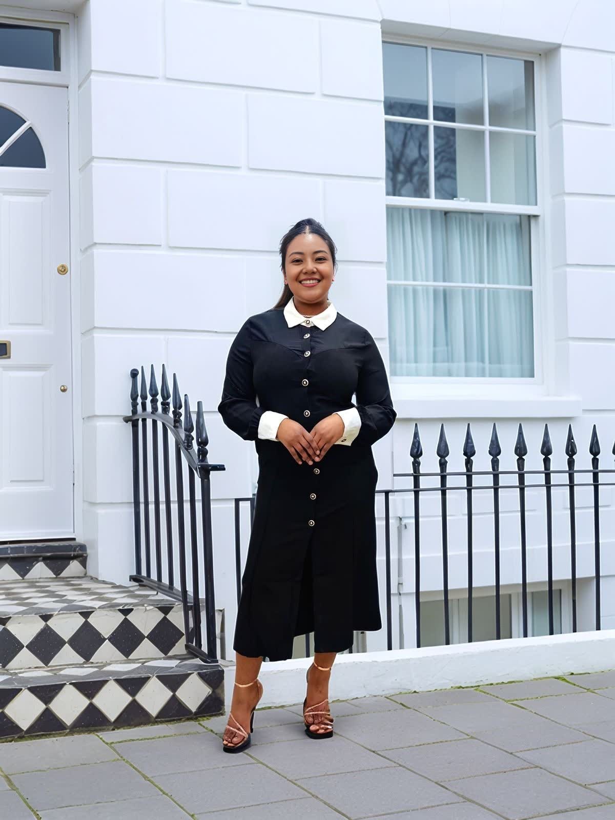 Black midi dress with contrast collar, long sleeves, and center-button detail