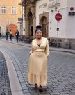 Nude ruffle maxi dress with V-neck and long sleeves, tiered ruffle skirt hem