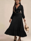 Black ruffle maxi dress with V-neck, long sleeves, and tiered ruffle skirt hem