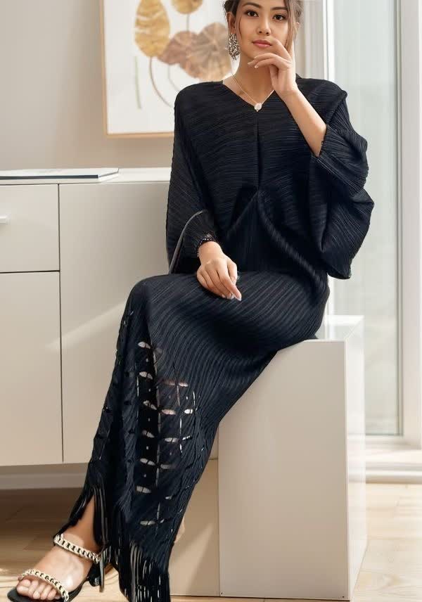 Black knit maxi dress with V-neck, loose fit, long sleeves, tassel fringe hem