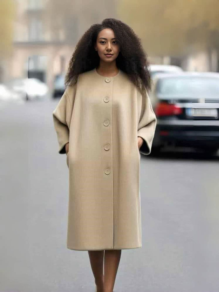Tan oversized long coat with button front, round neckline, and wide sleeves