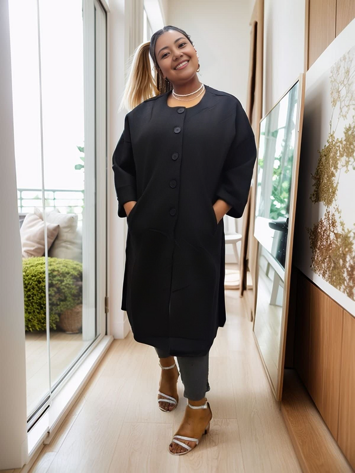 Black oversized long coat with button front, round neckline, and side pockets