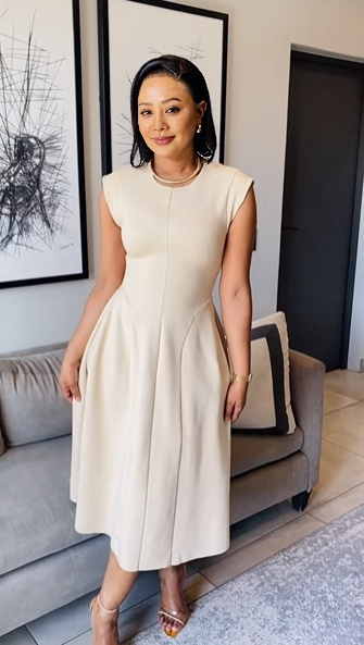 Beige A-line midi dress, sleeveless with round neckline and flared midi skirt
