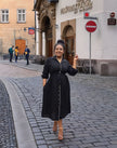 Black midi button-front dress with waist tie detail, long sleeves and V-neck
