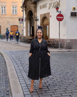 Black midi button-front dress with tie waist, long sleeves and V-neck