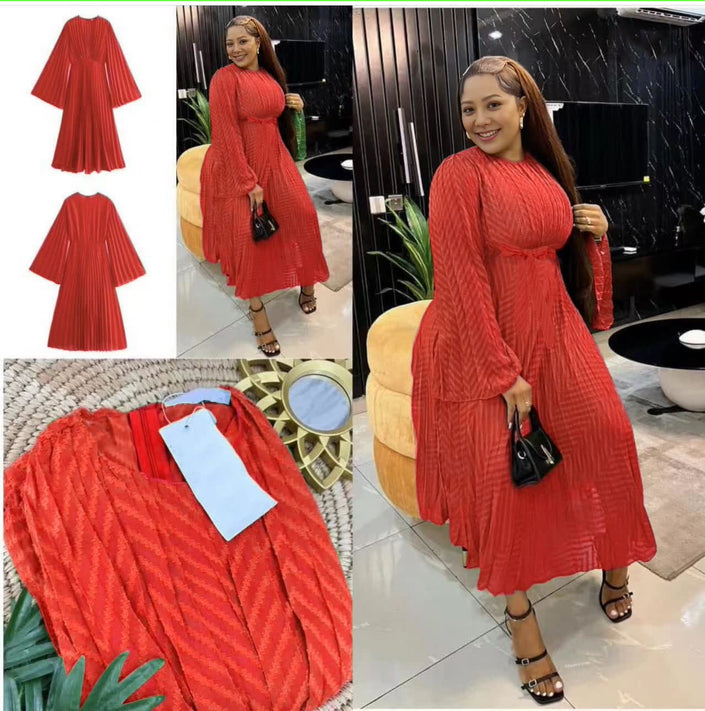 Red pleated midi dress with round neck and long sleeves, flowing gathered skirt