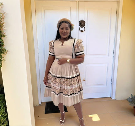 Embroidered puff-sleeve midi dress with tiered skirt and black-trim accents, cream