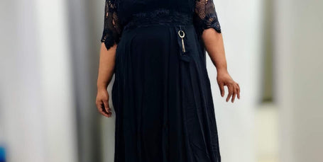 Black lace midi dress with waist ring detail, short lace sleeves and pleated skirt