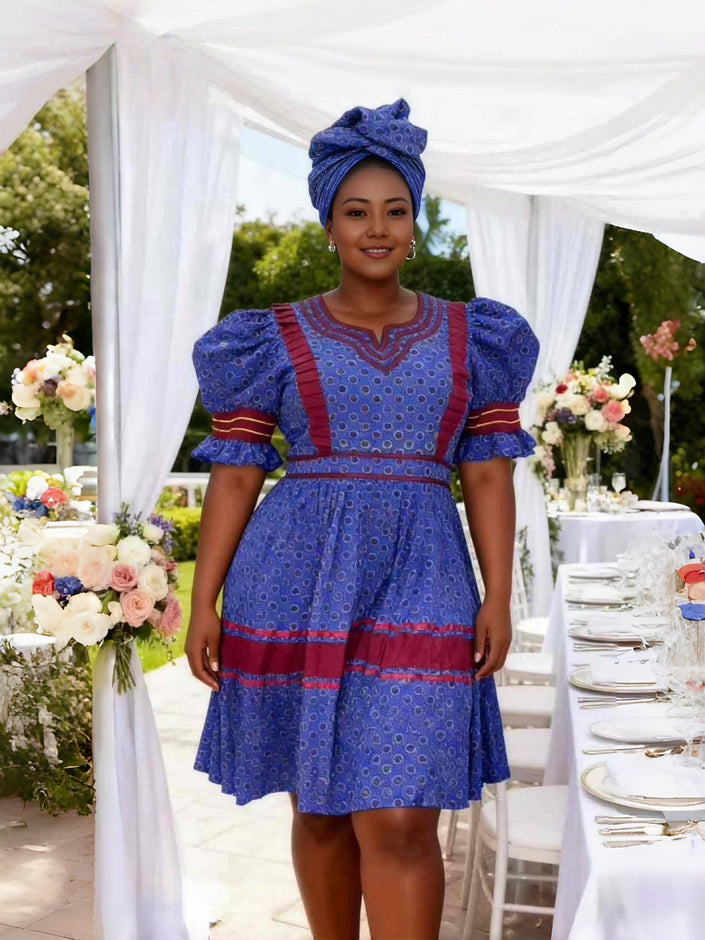 Blue puff sleeve dress with circular motif and tiered skirt with border bands