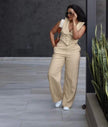 Beige wide-leg jumpsuit with sleeveless layered collar vest and buttoned bodice