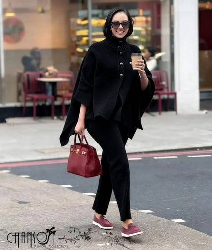 Black knitted high-neck cape twin set with buttoned front and matching slim pants