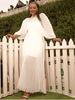 White pleated maxi dress with cinched waist and long, draped sleeves