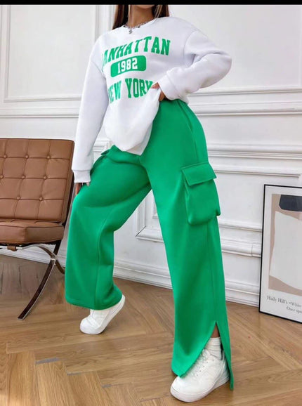 White cropped sweatshirt with green 'Manhattan 1982 New York' graphic on back