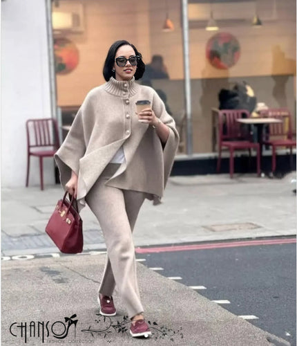Beige knitted high-neck cape twin set with buttoned front and flowing sleeves