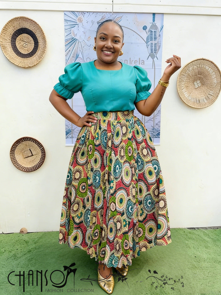 African print twin set with teal puff-sleeve top and multicolor patterned skirt