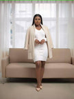 Beige midi coat jacket with open front, long sleeves, and flap side pockets