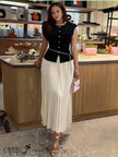 Black pleated knit midi dress with cap sleeves and button front
