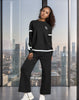 Black knit twin set: crew sweater and wide-leg pants with white stripe cuffs