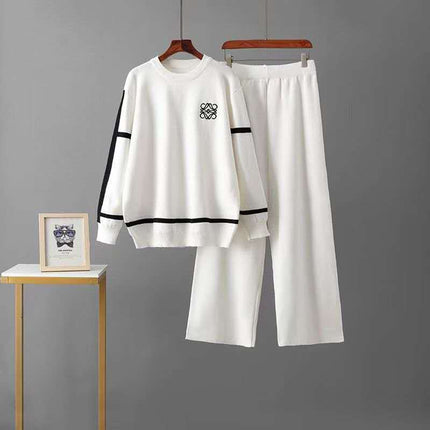White knit twin set: crew sweater and wide-leg pants with black stripe cuffs