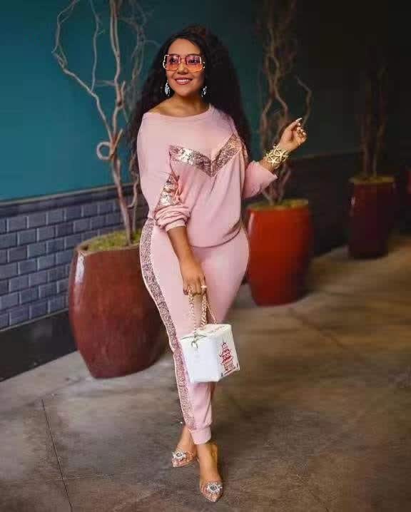 Pink lounge set with long-sleeve top and fitted joggers, lace-like side panel trim