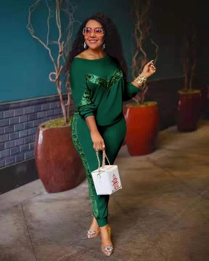 Dark green lounge set with long-sleeve top and fitted joggers, lace-like side trim