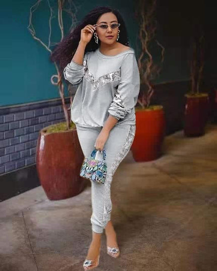Grey lounge set with long-sleeve top and fitted joggers, lace-like side panel detailing