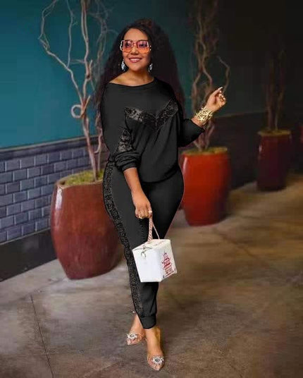Black lounge set with long-sleeve top and fitted joggers, lace-like side panel trim