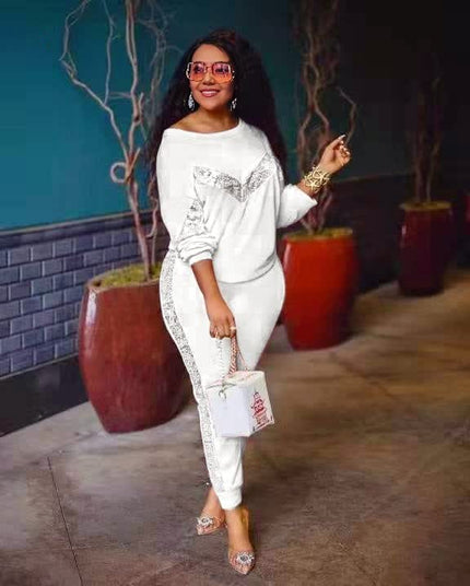 White lounge set with long-sleeve top and fitted joggers, lace-like side panel trim