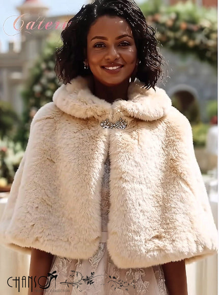 Beige faux fur capelet with rounded collar and decorative brooch closure