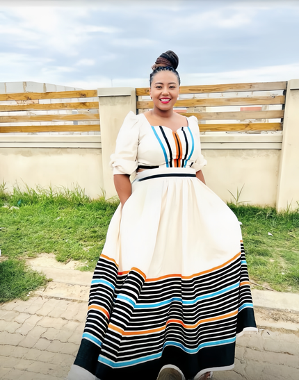 Maxi dress with puff sleeves and striped hem, white bodice with multicolor bands