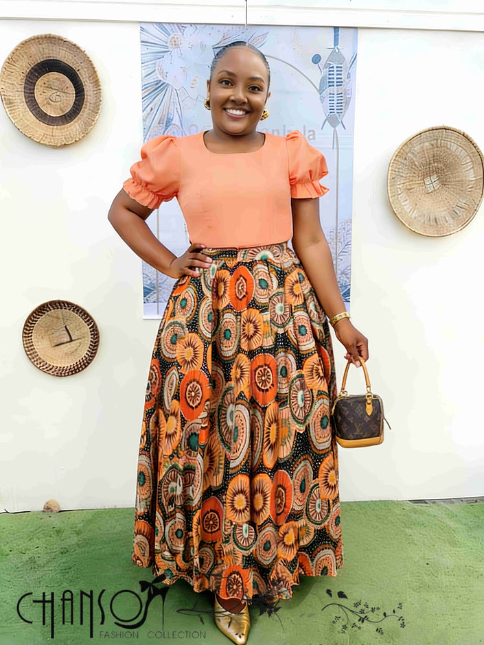 African print twin set with coral puff-sleeve top and multicolor patterned skirt