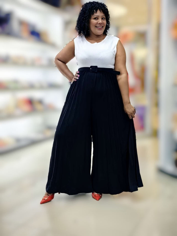 Belted wide-leg jumpsuit: white sleeveless bodice with black pleated skirt-pants