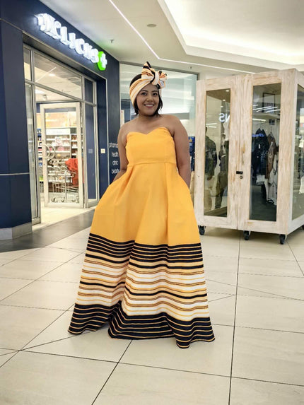 Strapless maxi dress in mustard yellow with striped flared skirt