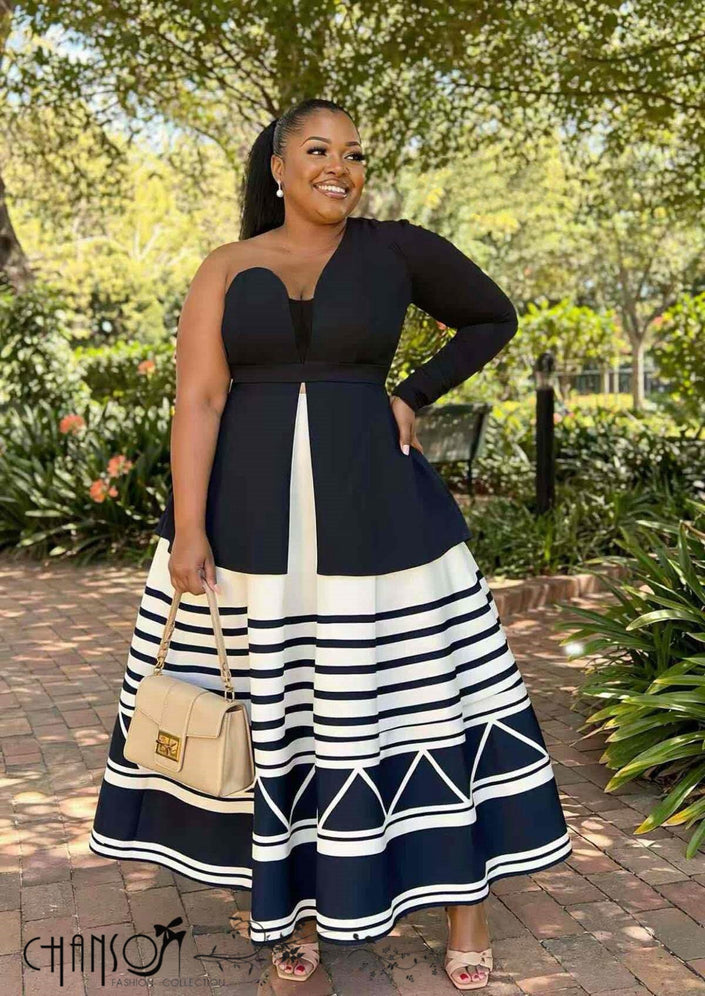 Black one-shoulder maxi dress with geometric stripe hem and flared skirt