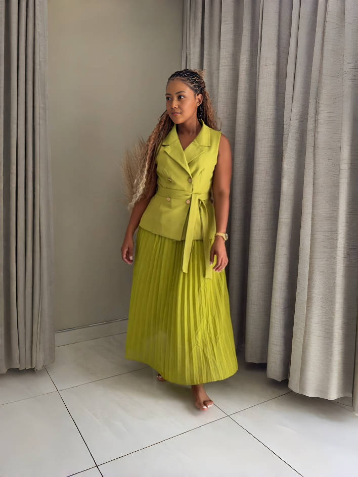 Yellow sleeveless belted blazer with pleated midi skirt, tie waist