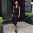 Black sleeveless belted blazer with pleated midi skirt, double buttons